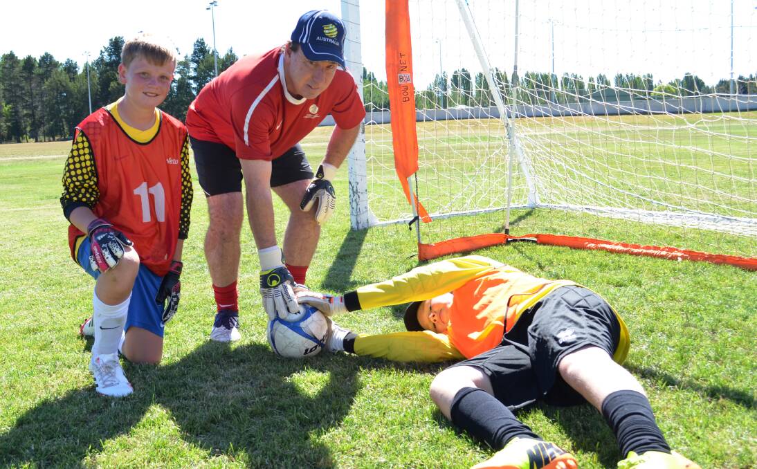 Tamworth's Lachlan Maker with state goalkeeping coach Andy Lennon and Lismore keeper Lachlan Murphy in Armidale on Saturday. Photo: Chris Bath 190114JA07