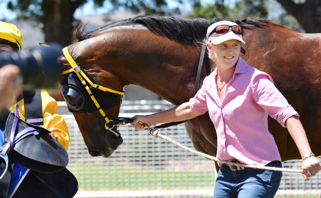 It all added up to a brilliant training debut for Sally Torrens when Subtract won at Tamworth yesterday. Here she celebrates the win with her former Victorian gelding. Photo: Barry Smith 310114BSA24