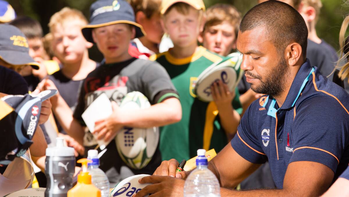 Kurtley Beale signs autographs for many young admirers at the recent Armidale rugby camp. Photo: Matt Bedford