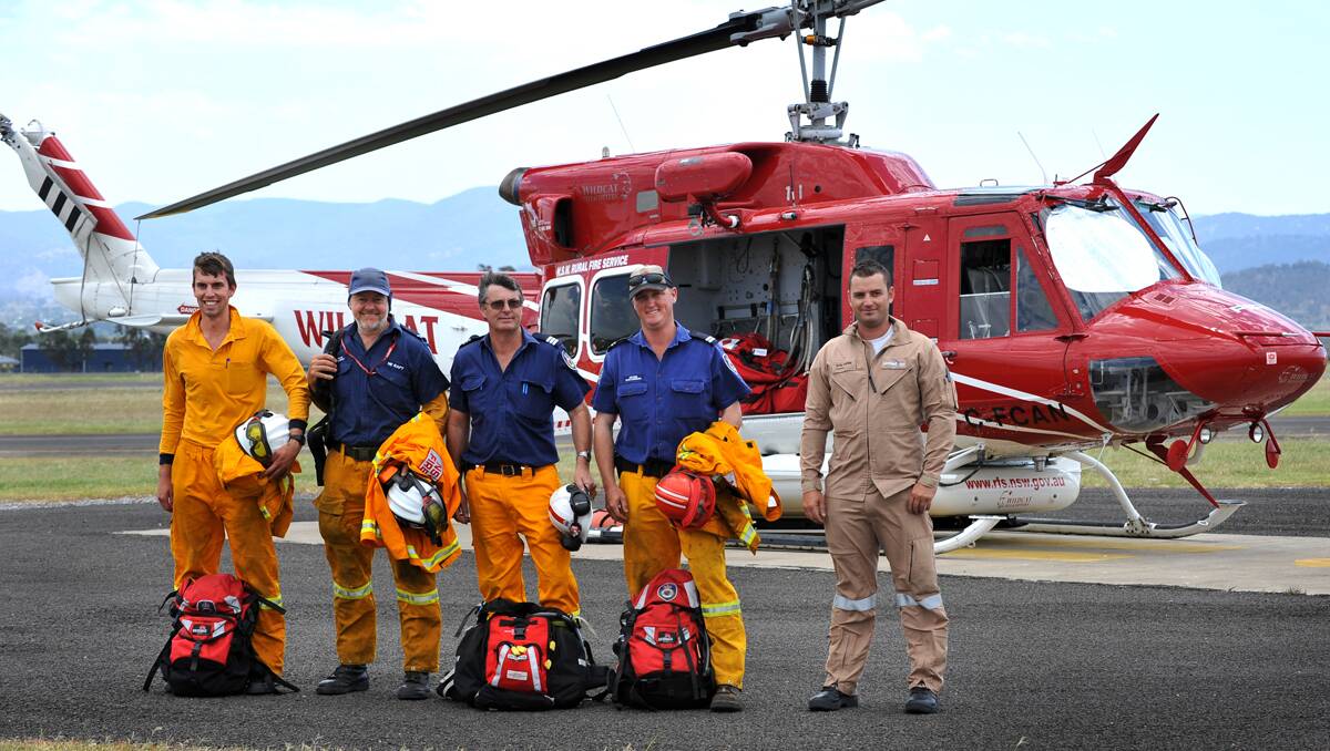 READY TO FLY: Toby Brunckhorst and Steve Tremont (both from New England remote area firefighting team), with John Jamieson and Peter Stevenson (both of Tamworth) and crewman Kris Larkin. Photo: Barry Smith 090113BSA06
