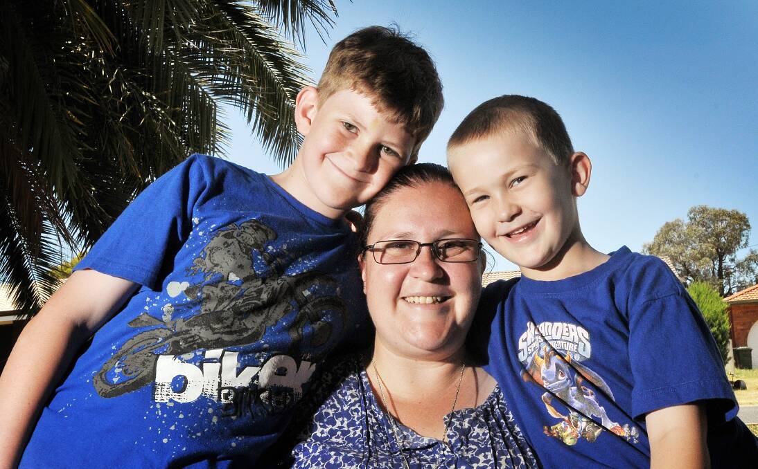 LEFT – ULTIMATE GIFT: West Tamworth single mum Cindy McCluand with sons Nicholas, 10, and Jayden, 6. Instead of spoiling her kids with presents at Christmas, Ms McCluand taught them a valuable lesson about giving. Photo: Gareth Gardner 311213GGD01