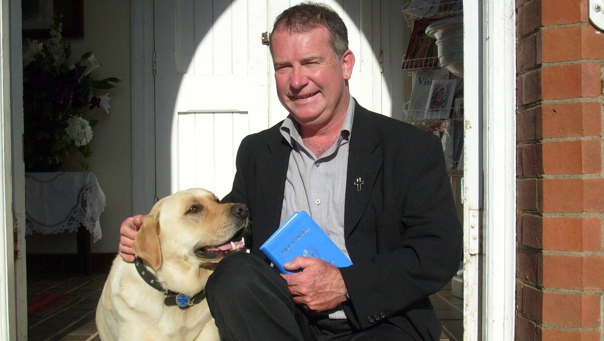 GUYRA CITIZEN OF THE YEAR: Father Anthony Koppman and his dog, Cracker.