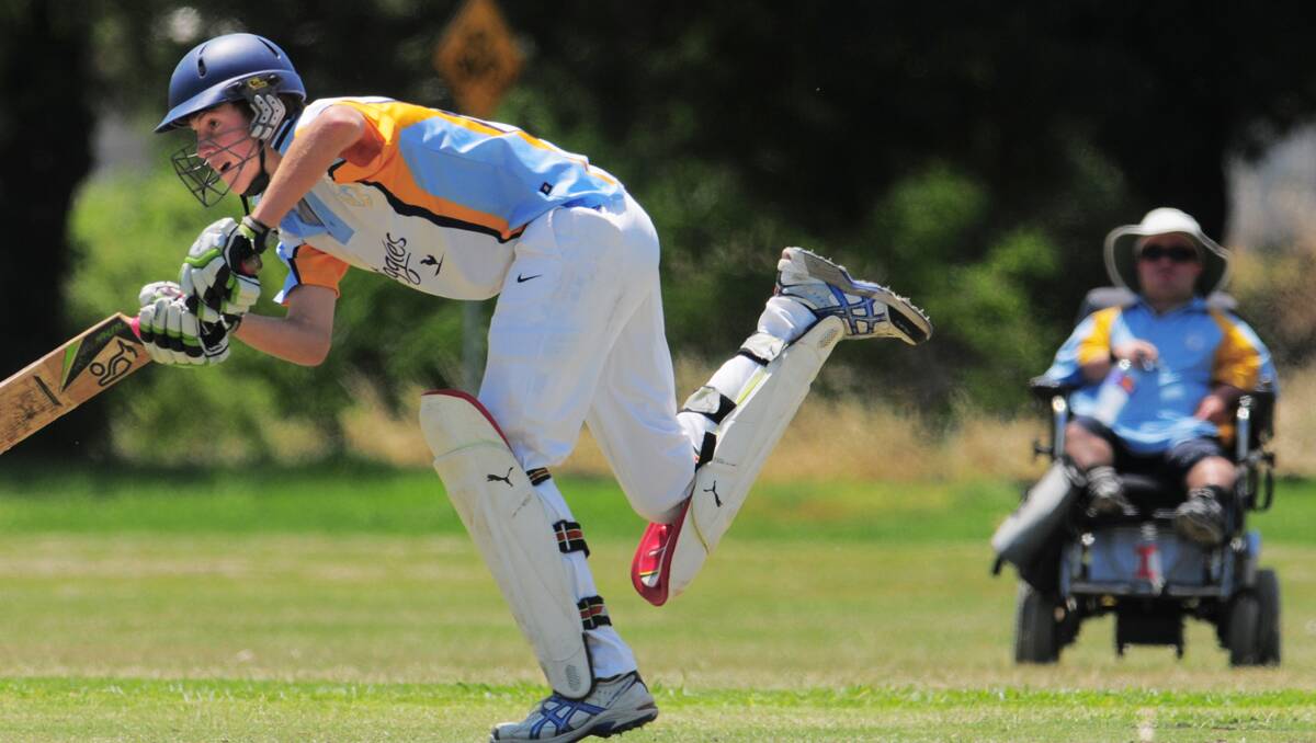 Lachlan Davidson on-drives in Sunday’'s Hunter Valley Junior Cricket Under 14 success against Upper Hunter. Coach Simon Hood is in the background umpiring at square leg. Photo: Barry Smith 161212BSD08
