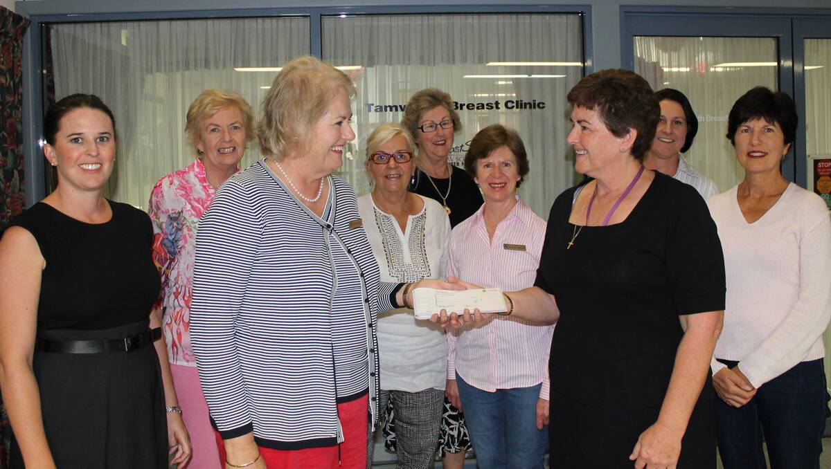 HAPPY HANDOVER: Serendipity Committee president Ruth  Campbell, left, presents Shayne McDonald of BreastScreen  Tamworth with $13,400 to go toward the refurbishment of the unit in Dean St.  With them, back from left, are Serendipity committee members Trina Constable, Mary Keft, Sandy Brooks, Adele  Holtsbaum, Robyn Barton, Breastscreen staffer Kelly Hall and  Serendipity’s Helen Tickle.