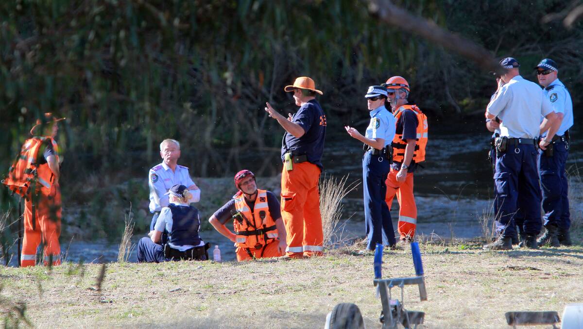 ACONCERTED EFFORT: Police and State Emergency Service personnel discussing search options on the Gwydir River neaAr Bingara yesterday. Photos: Robert Chappel 250912RCE16