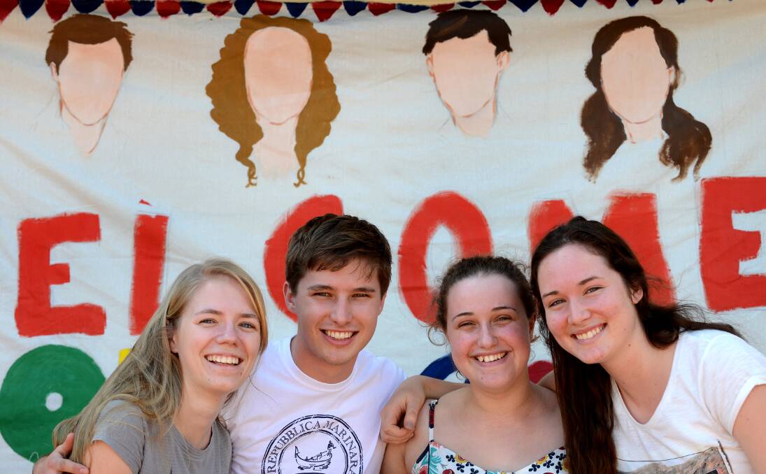 RETURNING HOME: In front of the ‘welcome home’ banner before Christmas were, from left, Lauren Mole, Tyler Coleman, Georgia Harvey and Rebekah Larkin. Absent was Sam Morris and Nick Larkin returned on Christmas Eve. Photo: Barry Smith  181213BSJ01