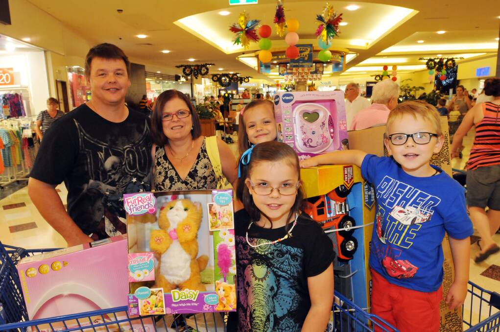 SHOPPING UP A STORM: Jay and Desiree Trengrouse with kids Kyrah (back), Trista and Cale appear outside Big W yesterday after a marathon shopping exhibition. 271213GOB01