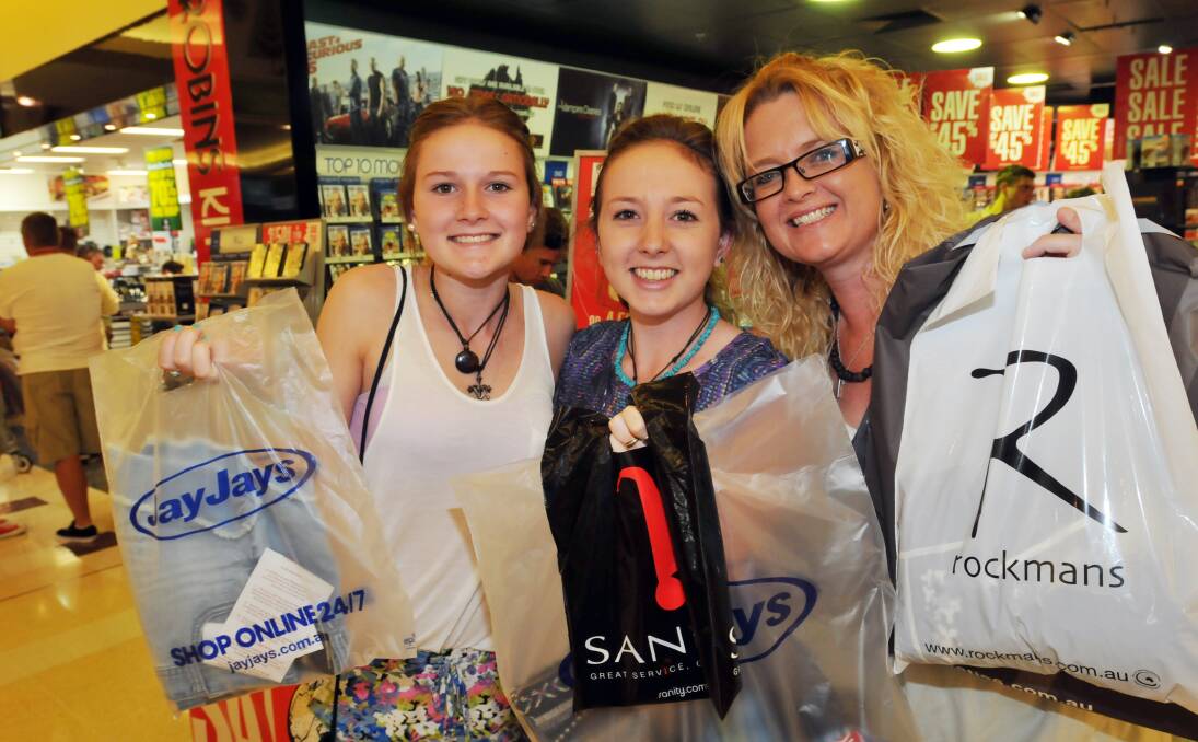 BARGAIN BUYS: Charlotte, Hollie and Belinda Perkins enjoy the post-Christmas Day sales at  Shoppingworld yesterday. Photos: Geoff O’Neill 271213GOB03