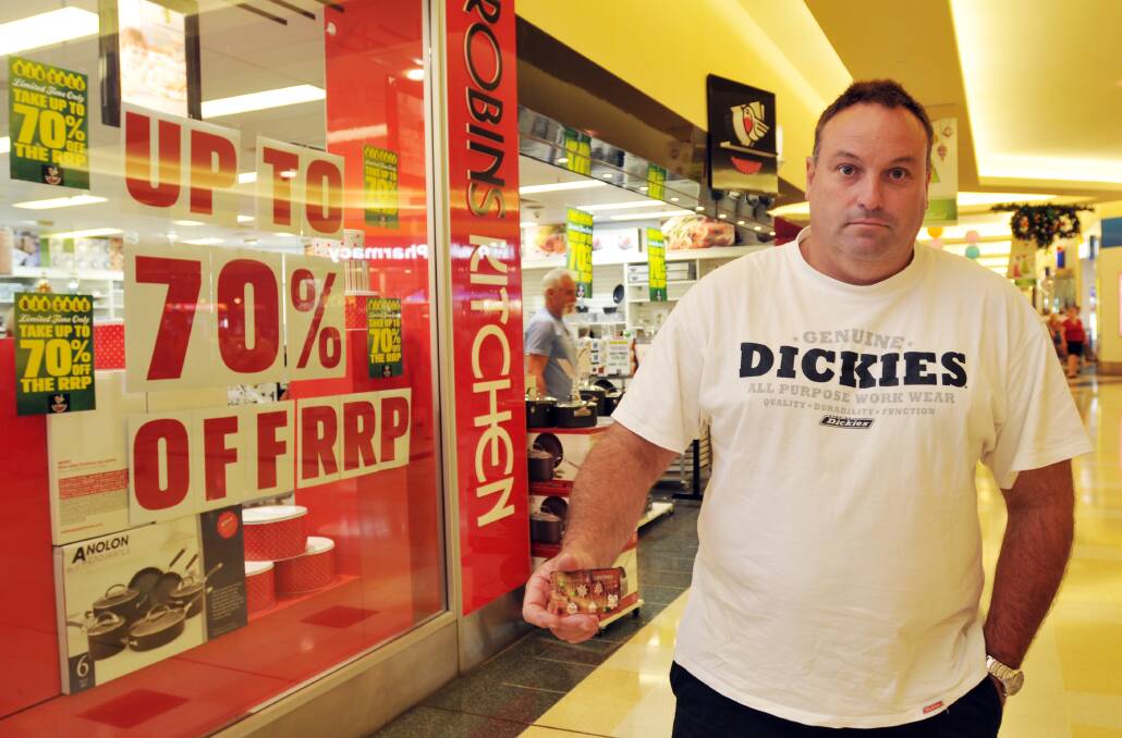 UNACCEPTABLE: Jason O'Brien was outraged yesterday to find he was unable to redeem his $200 gift  voucher at Robins Kitchen, which has gone into voluntary administration, after the store assured his wife all was well on Monday. Photo: Geoff O’Neill 271213GOA02