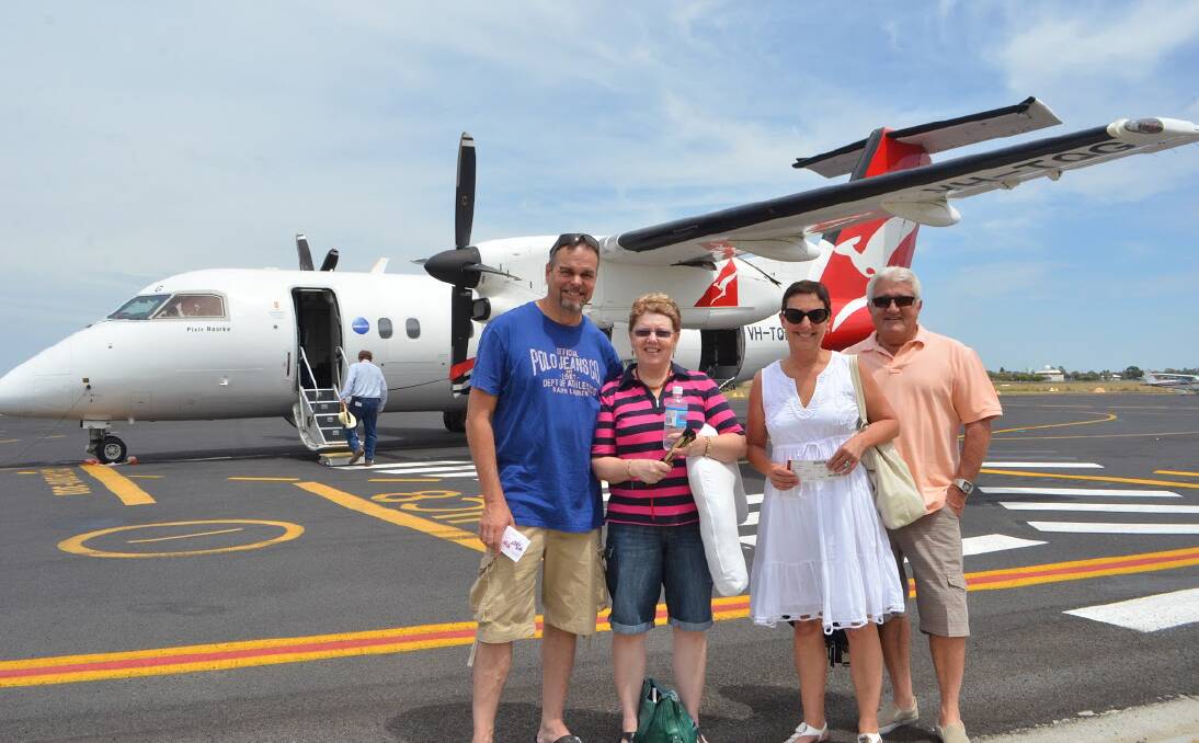 BACK IN THE AIR: Larry and Narelle Williams and Karen and Lachlan Smith head off to Sydney to spend Christmas with their families onTuesday's first official QantasLink relief flight since the collapse of Brindabella.