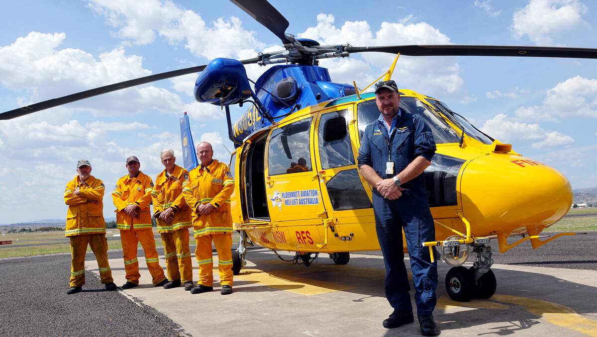 FLIGHT FOR FIRES: On standby are Rapid Aerial Response crew members, from left, Bob Greig from Wollombi, Rance Harrison from McCarthur, Michael Elfick from Bowthorn, Paul Ryan from Berowra and pilot Chris Wilcock, who is based with the chopper in Taree.  Photo: Geoff O’Neill 301112GOD02