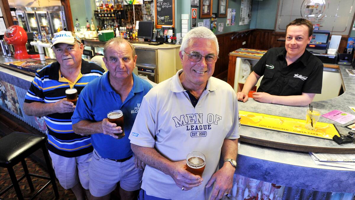 Men of League (from left) Greg ‘Nugget’ Cooper, Nifty Neville Clayton and Zeke Elsley share a few memories with Family Hotel barman Brad Burns. Photo: Barry Smith 271012BSE01