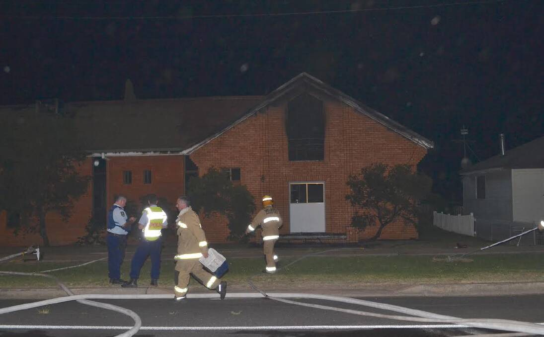 CHARRED REMAINS: Police and fire crews survey the damage of the Seventh Day Adventist Church which erupted in flames on Friday night. Photo: Inverell Times