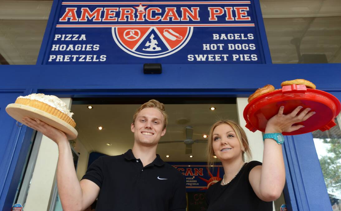 BIGGER THAN TEXAS: Team members of new Peel St shop American Pie, Tim Robinson and Tahlia Gee, display some of the cafes Yankee food.  Photo: Barry Smith 100114BSB02