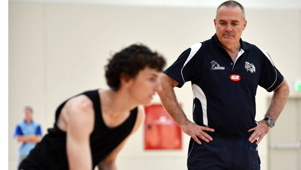 Rex Nottage looks on as young Thunderbolt up-and-comer Adam Swindale completes a drill during one of the coaching clinics Nottage ran last weekend. Photo: Barry Smith 030313BSE12