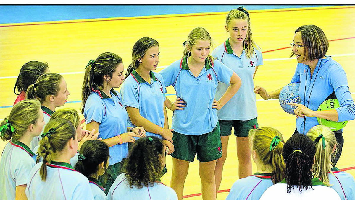 GOOD ADVICE: Liz Ellis, the netball coach, gives PLC and Glen Innes girls some netball tips. 