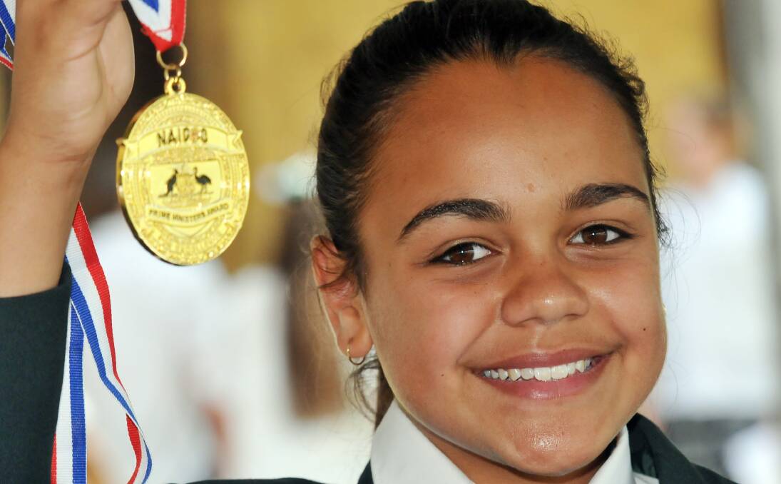 HIGH ACHIEVER: Peel High School’s Janaya Lamb shows off her latest piece of hardware – a Prime Minster’s medal for excellence. Photo: Geoff O’Neill 101213GOD01