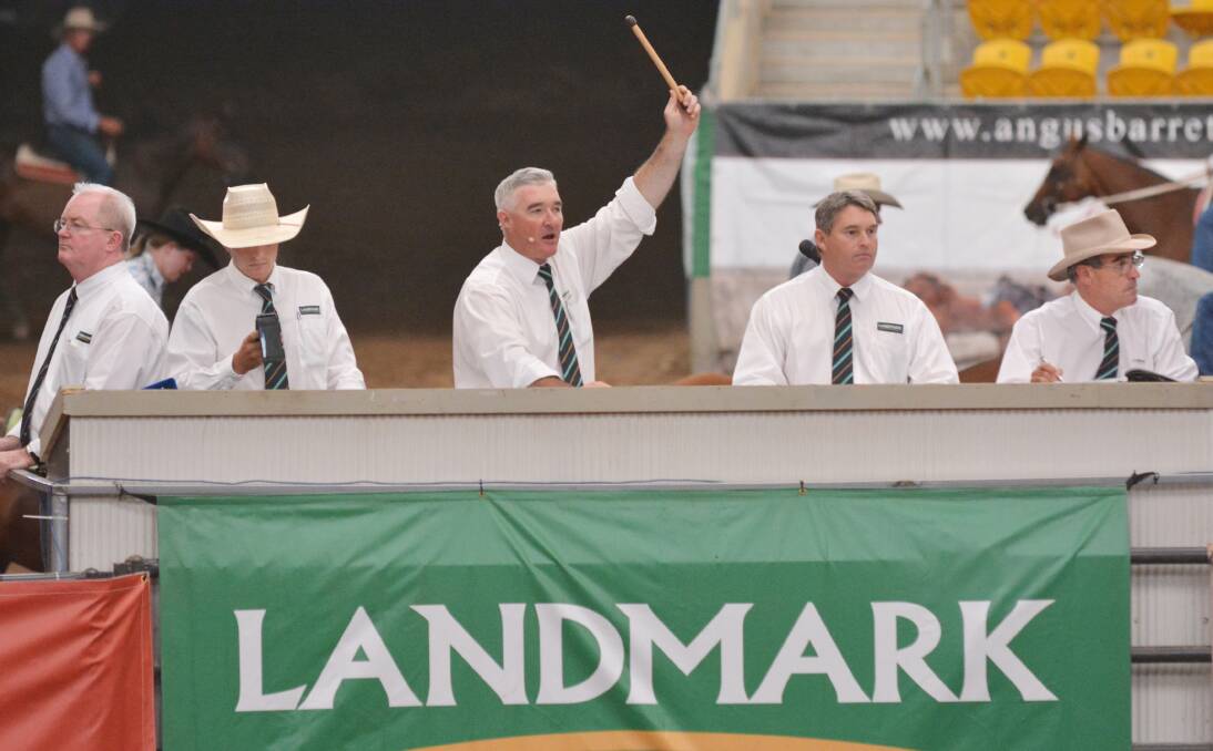 GOING, GOING, GONE: Landmark's national livestock director, Mark Barton, centre, makes a sale at the annual Classic Campdraft Sale in Tamworth over the weekend as, from left, Brendon Wade, Joel Fleming, Michael Lawton and Kevin Northey keep an eye out for bidders in the crowd. Photo: Barry Smith 070214BSB09