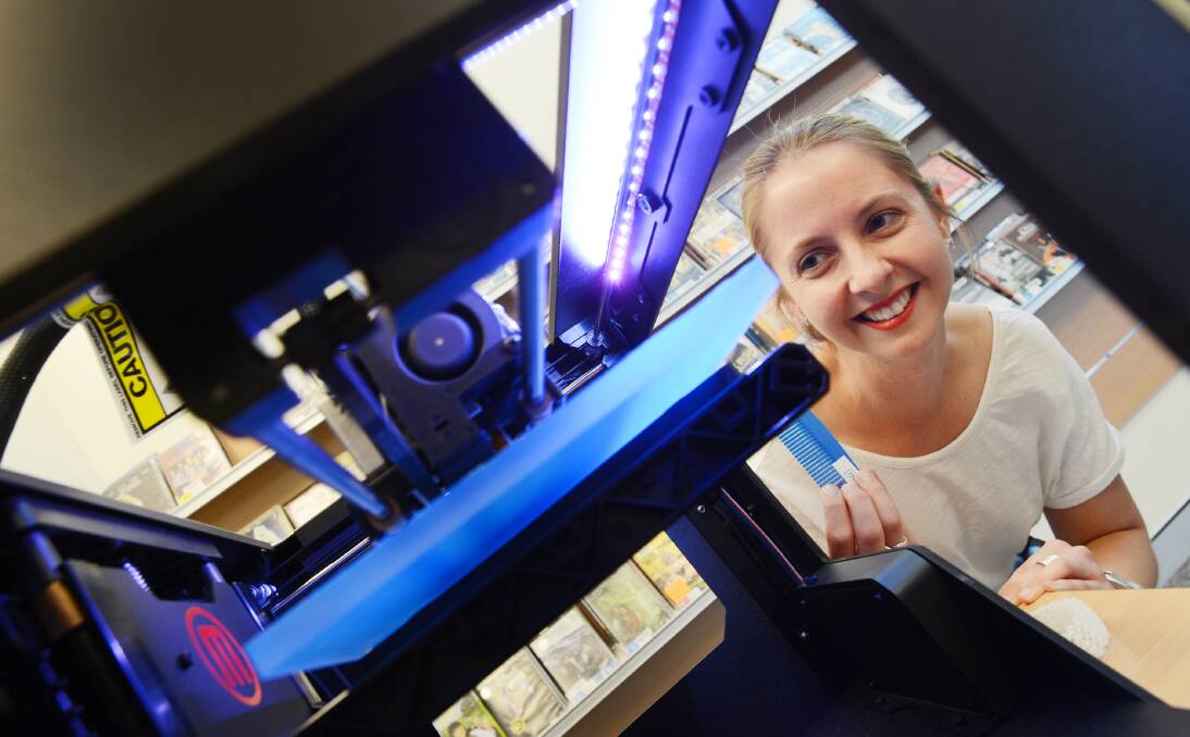 CUTTING-EDGE: Tamworth Regional Library’s reader  services librarian Amanda Burke takes a look at the new 3D  printer. 070214BSD03