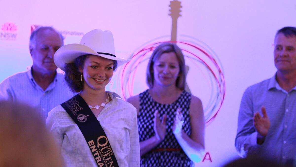 Queen Quest entrant Alana Johnson receives her sash and famous Queen quest Akubra hat in a ceremony at the Fanzone. Photo: Robert Chappel