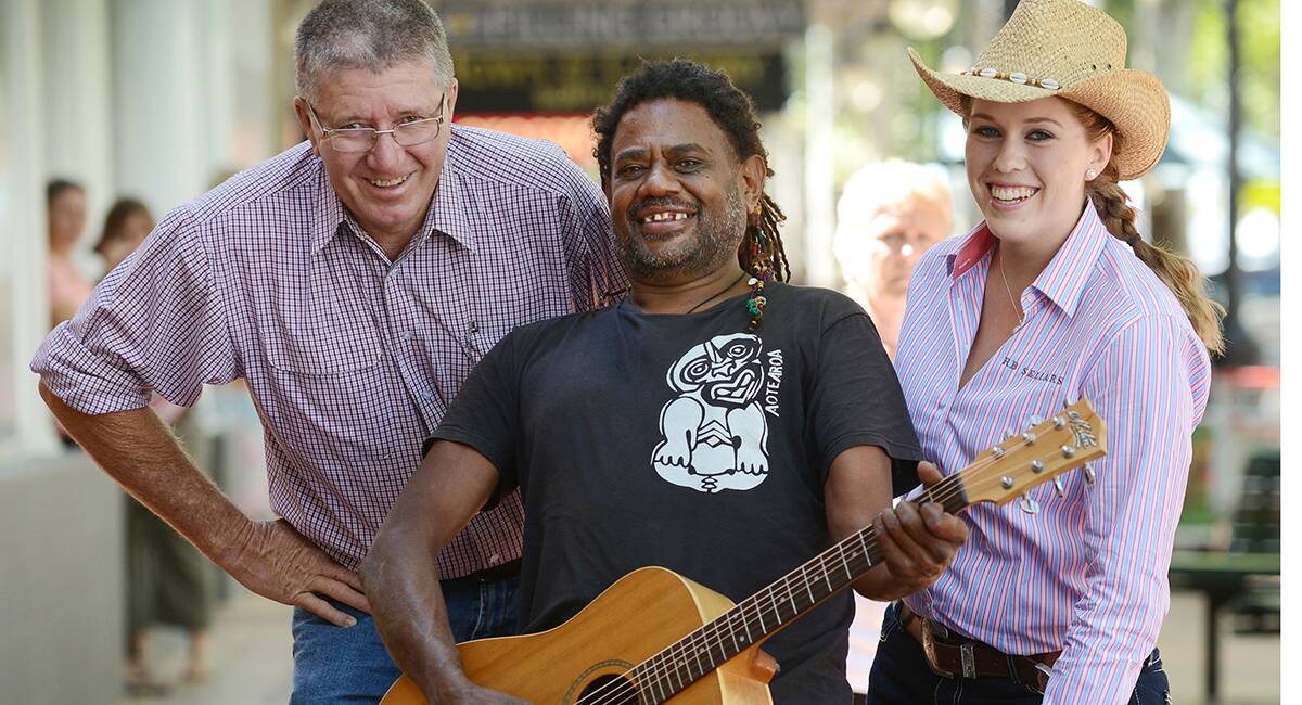 STEP RIGHT UP: Mayor Col Murray, left, busker Lewis Parter from Bowen in northern Queensland, and country music queen entrant Nicole Whiting kicked off the busking championships for 2014 yesterday.  Photo: Barry Smith 150114BSB04 