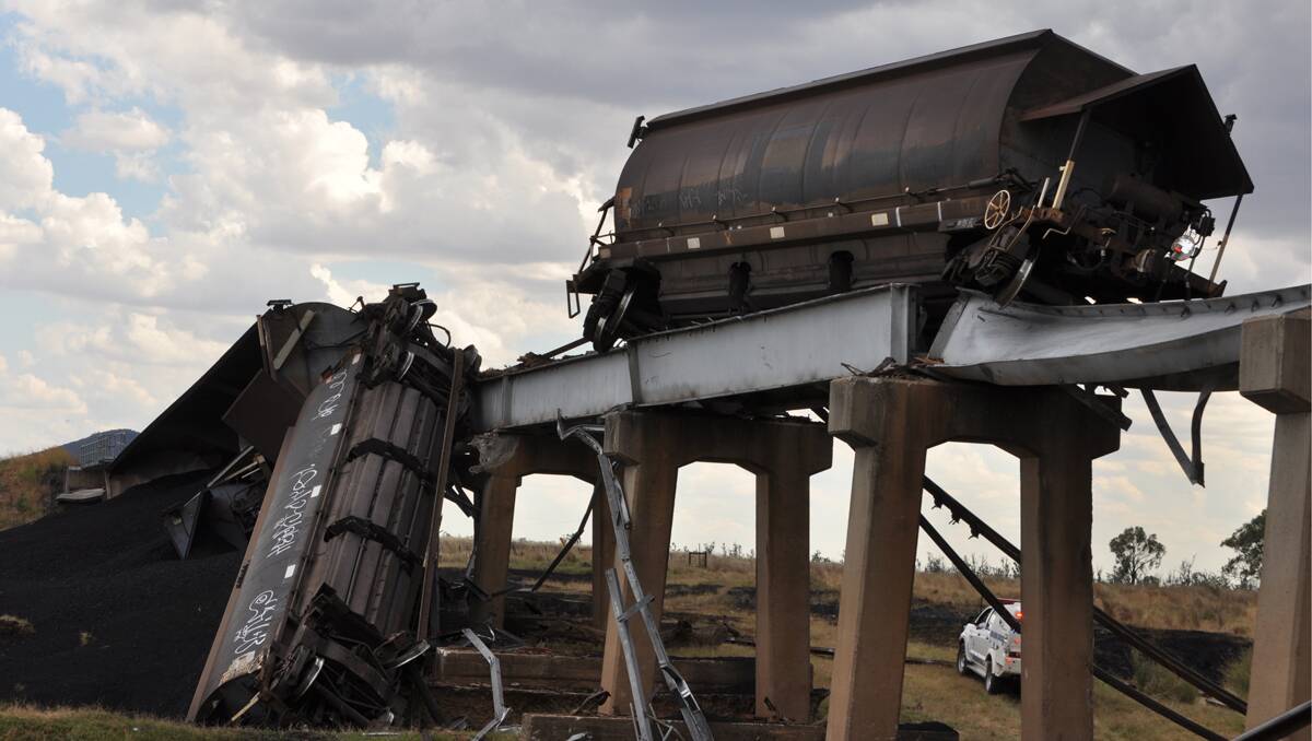 A cleanup is underway this evening after a full-laden coal train derailed in spectacular fashion from a bridge near Boggabri this afternoon. Photo: Keith Millerd