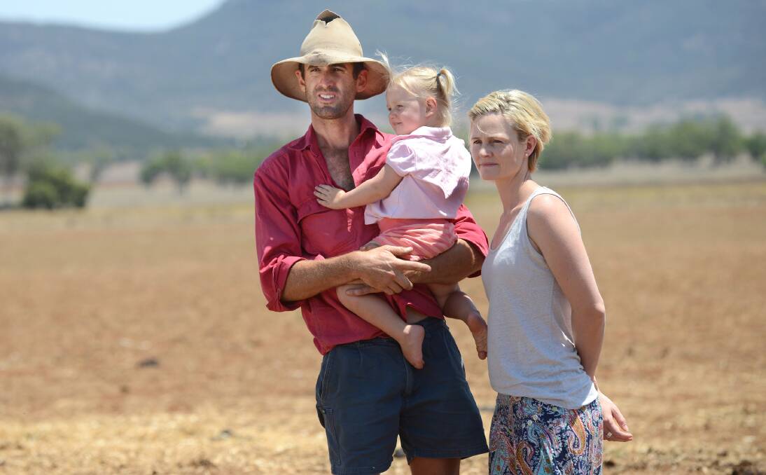 FUTURE AT STAKE: Fourth-generation Kelvin farmer Daniel Knapman with wife Fiona and one of his two children, Josie, 2, is among the thousands of locals calling on NSW Primary Industries Minister Katrina Hodgkinson to officially drought-declare the region.  Photo: Barry Smith 040214BSD09