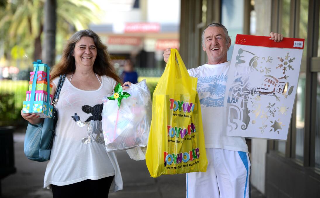 CHRISTMAS SHOPPING: Julie-Ann and Geoff Silvey loaded up with some of their Christmas presents. Photo: Barry Smith 021213BSD01