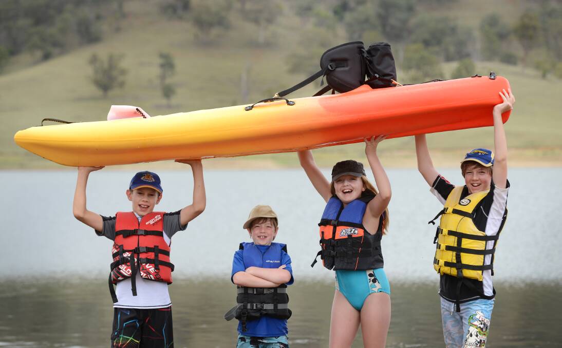 HOT AND HAPPY: Among the campers enjoying Chaffey Dam this week have been  Cooper, 11,  and Jonny Edwards, eight, from Brisbane, Layne MacPherson, 10,  from Nemingha and Ben Edwards, 12,  from Brisbane, who were visiting their Tamworth grandparents. Photo: Barry Smith 090114BSB02