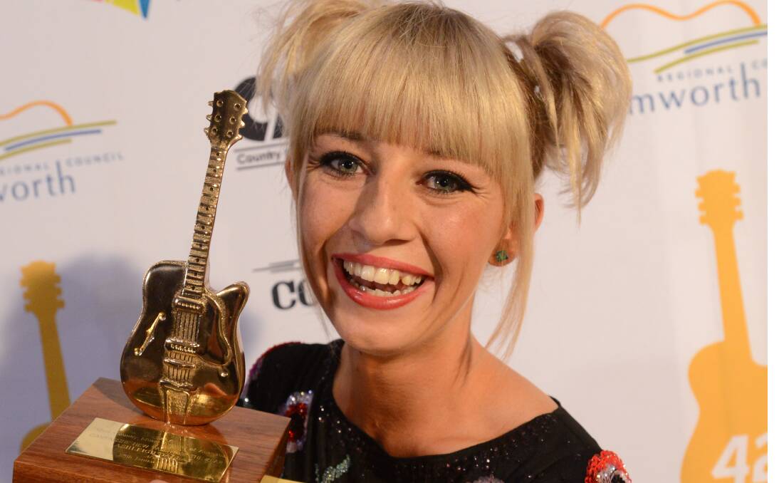 HOMETOWN HERO: Asheigh Dallas with her Golden Guitar for QantasLink New Talent of the Year.  Photo: Geoff O’Neill 250114GOA49