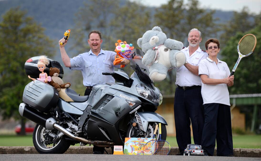 CHRISTMAS JOY: Ulysses member Rod Thompson, Salvation Army Major David Rogerson and Ulysses member Robyn Procter are ready to collect hundreds of toys this weekend.  Photo: Barry Smith 221113BSA01
