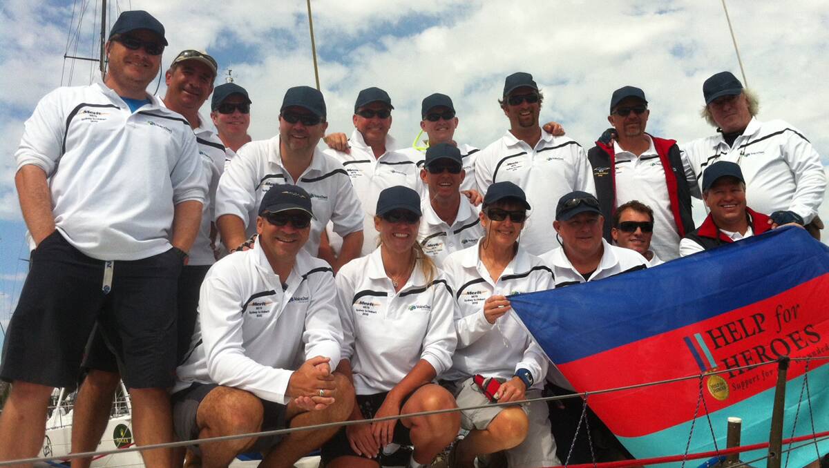 BEFORE THE RACE: Merit’s crew with Denise Bruschweiler, front row third from right, and the boat’s owner, Leo Rodriguez, front left, in Sydney Harbour before the start of the Rolex Sydney to Hobart Yacht Race on Boxing Day.