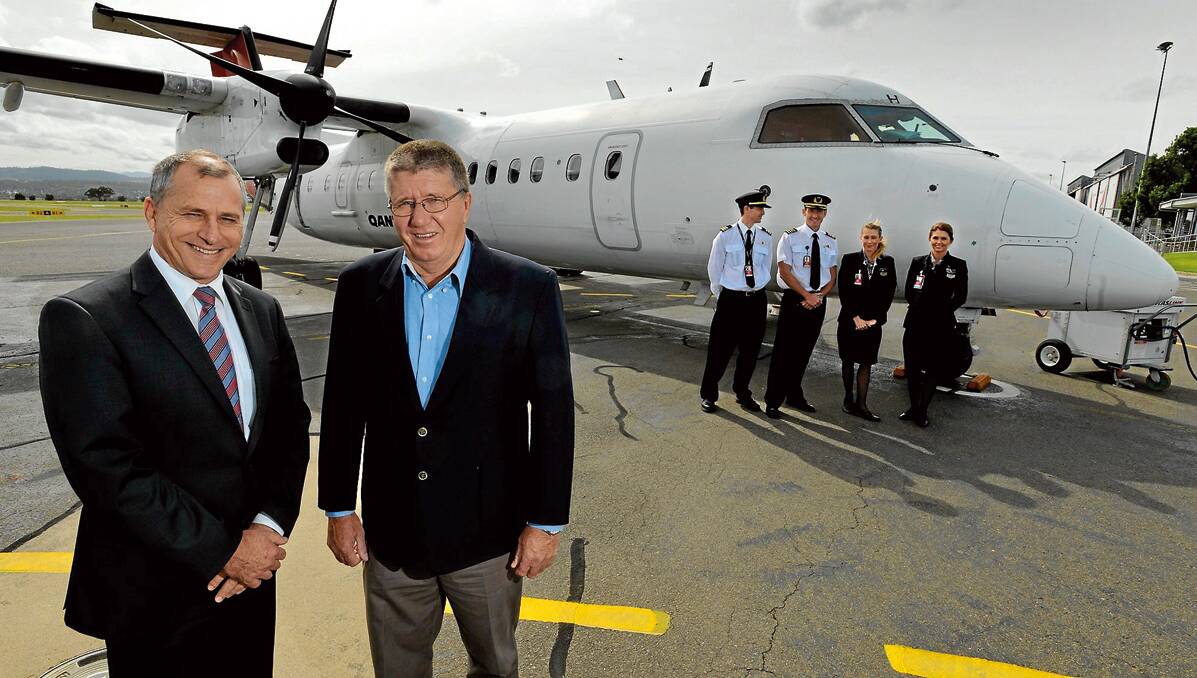 WELCOME HOME: QantasLink executive officer John Gissing and Tamworth mayor Col Murray. Behind – flight officer Daniel Lauder, Captain Brendan  Burchgart and flight  attendants Erin Hobday and Jessica French-St George.  Photo: Barry Smith 220213BSB06