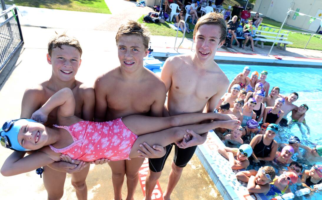 Kootingal Moonbi Swimming Club’s Apen McLean (6)  held up by (from left) Kelby McLean (12), Luke Johnstone (13) and Josh Nash (14). They are all part of a recordbreaker about to explode on Sunday. Photo: Barry Smith  070114BSG02