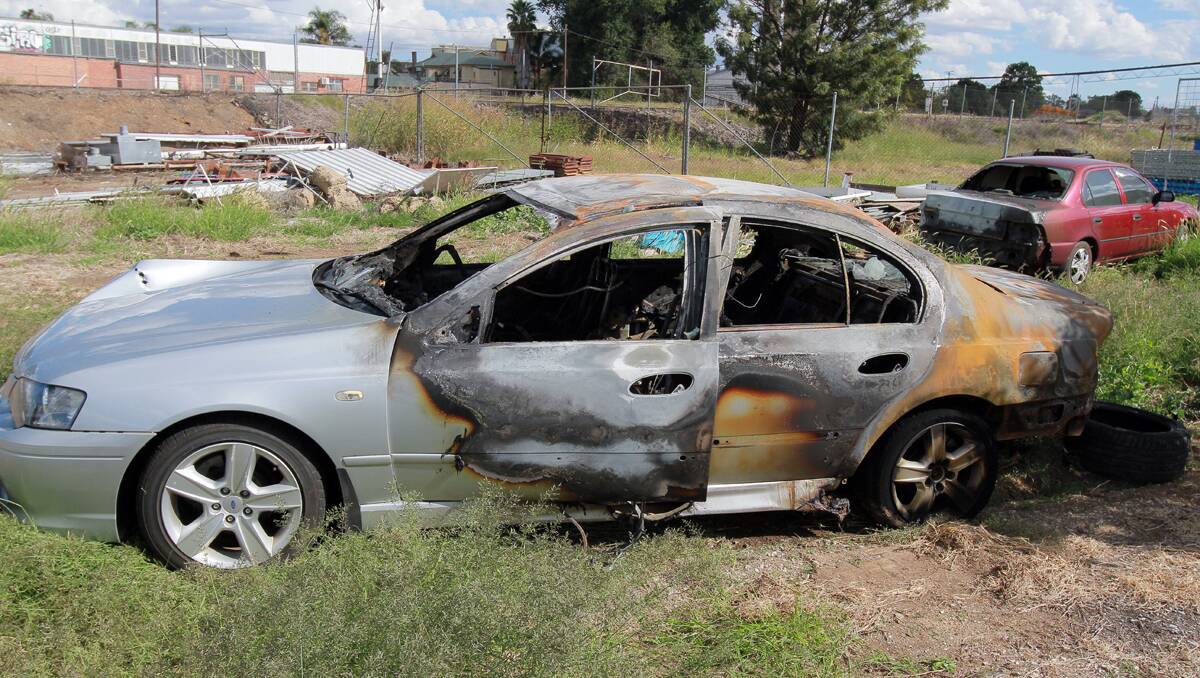 DESTROYED: The burnt-out cars left in Centenary Park yesterday morning were recovered for insurance assessment. Photo: Robert Chappel 190313RCA09