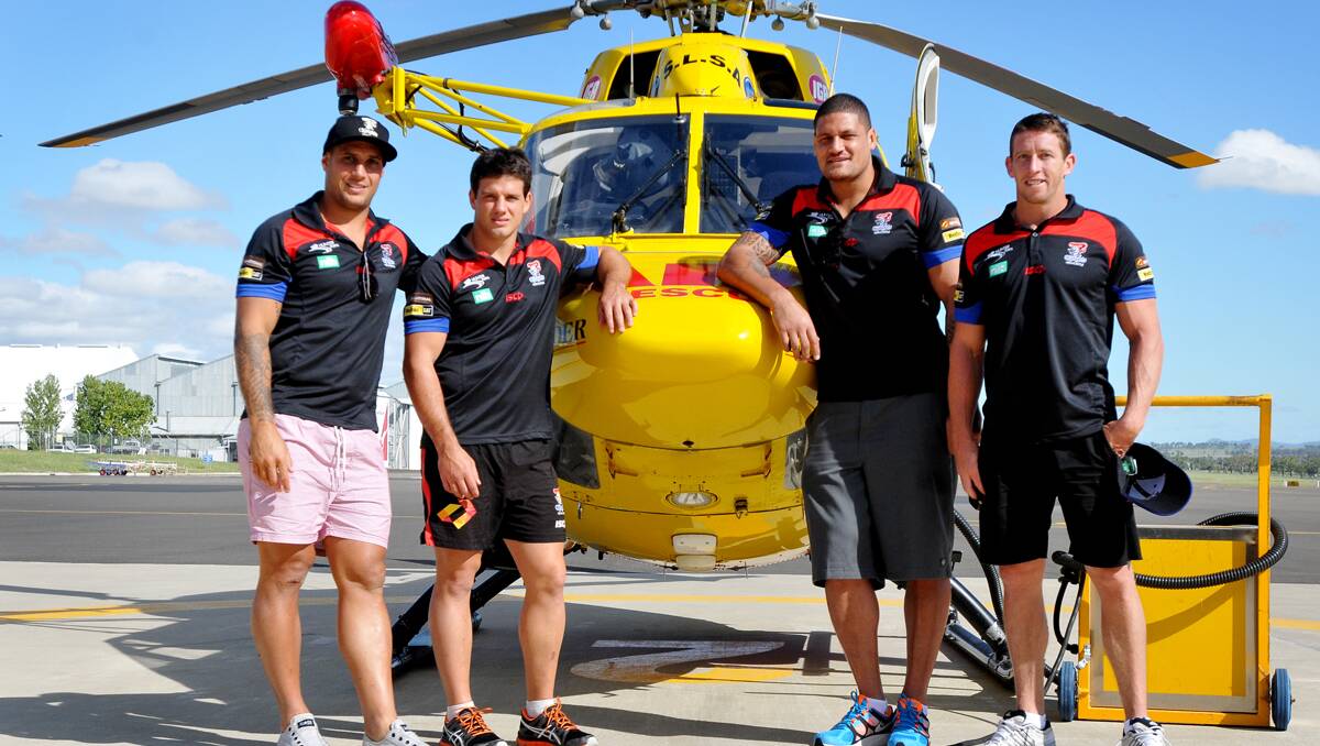 TAKING OFF: Knights players prepare for their trip out to Coonabarabran yesterday. From left are Jeremy Smith, Chris Adams, Willie Mason and Kurt Gidley. 200213GRA03