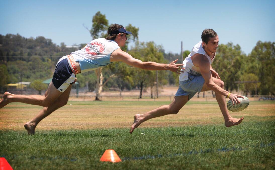 James Perrett dives after Jimmy Pascoe in the men’s touch shootout. Photo: Sarah Hickey
