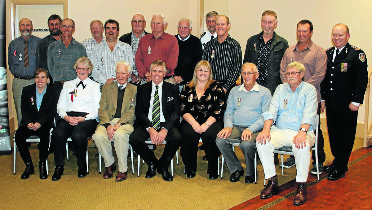 FIRIE FRIENDS: The Rural Fire Service had a chance to thank some of its long-serving members last week. Front from left, Kathleen Edwards,  Carolyn Noon, Bruce Cooper, Councillor Phil Betts, Robyn Perry, Noel Cook, Alan Thirlwell. Standing from left, Colin Noon, Simon Blake, Neville Henry, Ken Hawes, Robert Gill, Denny Summers, Paul Streeter, National medal recipients Charles May and Brian Tomalin, Graeme Whitten, Robert McCulloch, Stephen  Walters and RFS  Commissioner Shane Fitzsimmons.