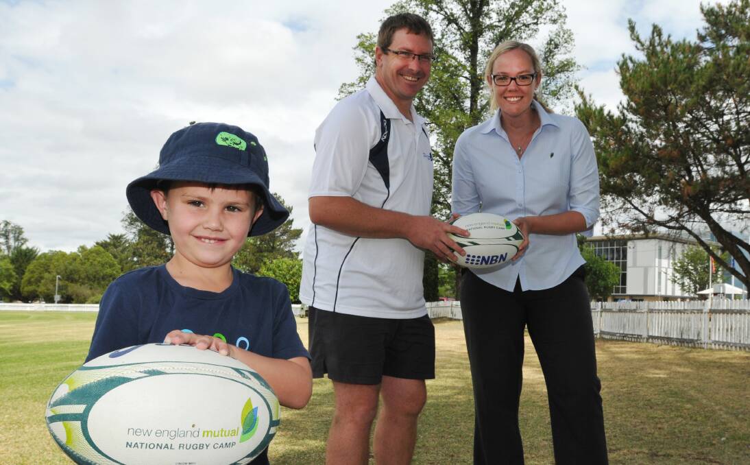 Ready for a big rugby camp are (front) Luke Schmude, camp coordinator Paul Schmude and Victoria Brown representing major sponsors New England Mutual.  Photo: Geoff O’Neill 080114GOC01
