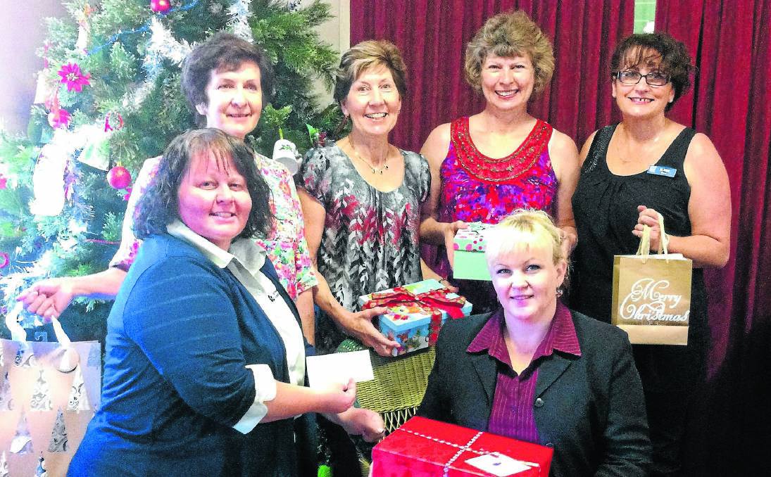 TOP GIRLS: Women’s refuge representative Charmaine with TOP executives Liz Hetherington, Robyn Tourle, Sue Hombsch, Eleze Drew and Roz Mitchell, front right, at the Christmas presentation.