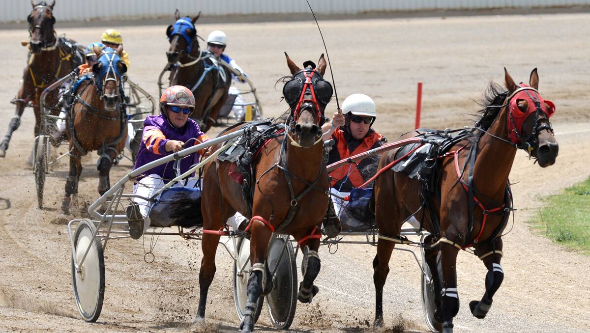 Smooth Cha Cha and Rod Pike about to grab the upper hand from Shannon Harmey and Miss Flick at Tamworth Paceway on Thursday. It was the first leg of a winning double for the former Tamworth trainer/driver. Photo: Barry Smith 210213BSG02