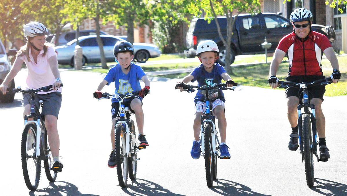 CALL FOR ADDED SAFETY: Nathan Lewis, far right, pictured with wife Fiona and sons Noah and Declan, would like to see more bike lanes installed around the city. Photo: Geoff O’Neill 111013GOH02