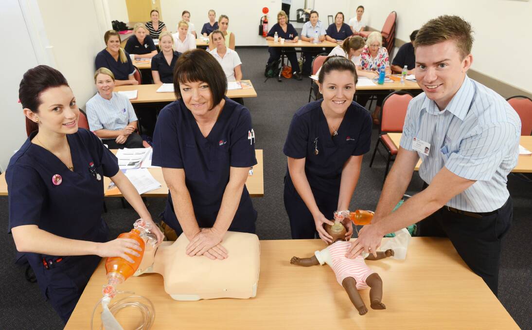 NEW BLOOD: From left, nursing graduates Ashleigh Foy, Roxane Burgess-Jones, Jessica Nixon and Jeremy Hatfield go over the basics on their first day of orientation. Photo: Barry Smith 100214BSA01
