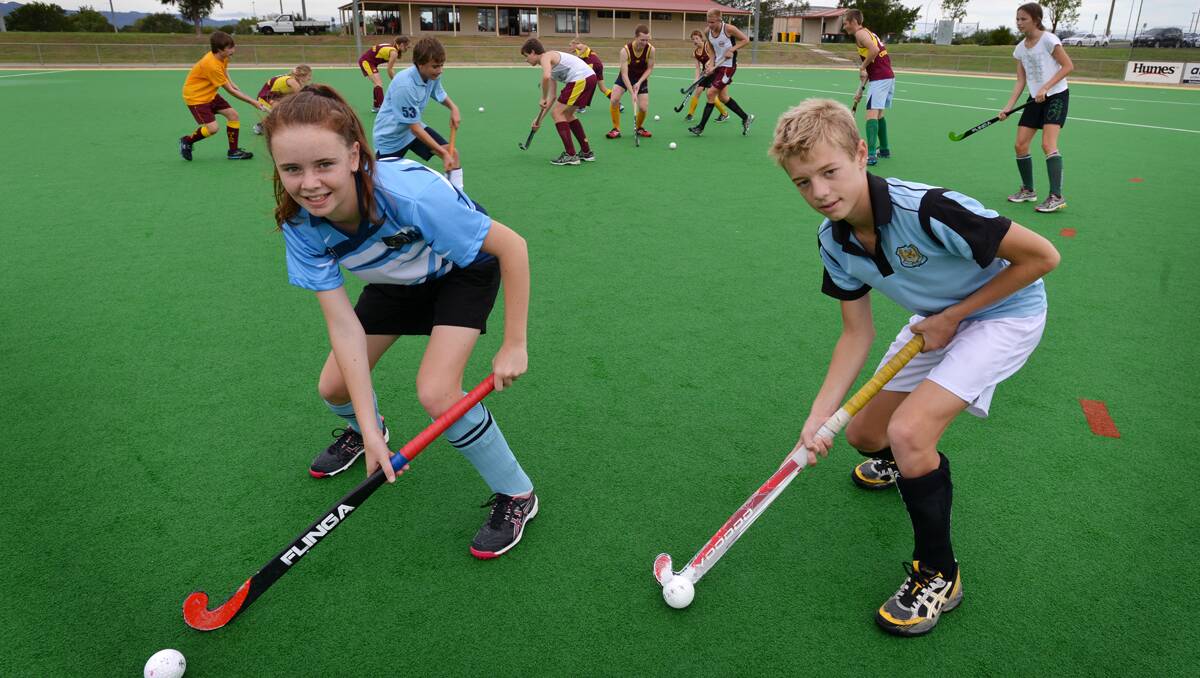 LEFT: Rebecca Willis (left) and Addison Coutman (right) prepare for their first City-Country clash on Saturday with their 11 fellow Tamworth Country representatives  yesterday.  Photo: Barry Smith 260213BSF01
