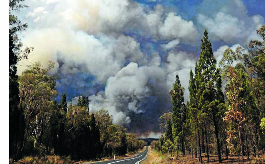 RAGING INFERNO: A giant plume of smoke filtered hundreds of metres into the air as  RFS crews battled to contain a blaze east of Coonabarabran late yesterday. Photo: Mudgee LAC Police