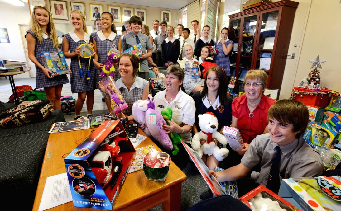 GIFTS GALORE: Oxley High School’s student representative council with the spoils from their annual Christmas appeal. Front, from left, SRC vice-president Alisha Perry, Salvation Army’s Annie O’Regan,  SRC member Letitia Morris, Uniting Church representative Lorraine Furze and SRC member Harry Lewin. Photo: Barry Smith 061213BSA02 