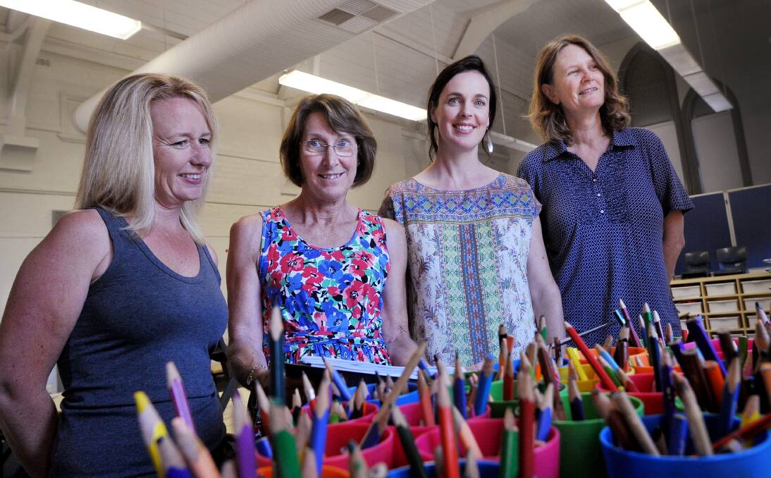 PENCILS SHARPENED: The kinder teachers at Tamworth Public School put their heads together  yesterday to prepare for their young charges’ first day at school tomorrow. Among this year’s kinder teachers are, from left, Brooke Unsworth, Denise Griffith, Belinda Judd and Sue Klingsch.  Photo: Gareth Gardner  280114GGA01
