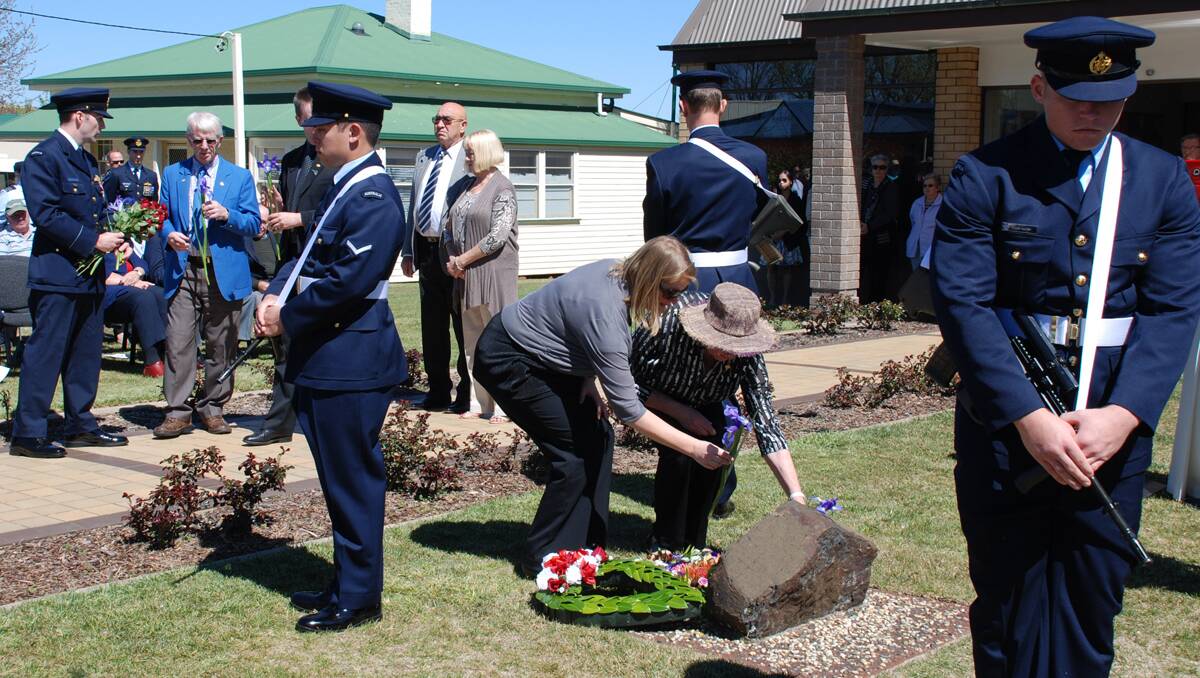 NEVER FORGOTTEN: Members of the McNess family pay a floral tribute to pilot Flight Lieutenant Jeremy McNess, lost in an F-111 crash above Guyra 20 years ago. Photo: Guyra Argus