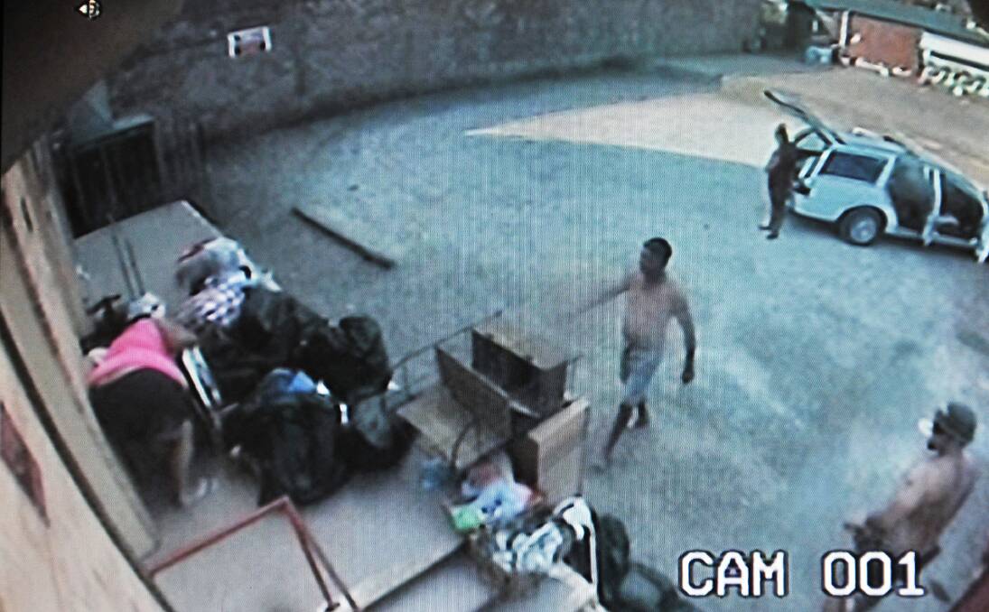 STEALING FROM CHARITY: Four men prepare to steal from the Salvos Tamworth donation dock on Saturday afternoon.