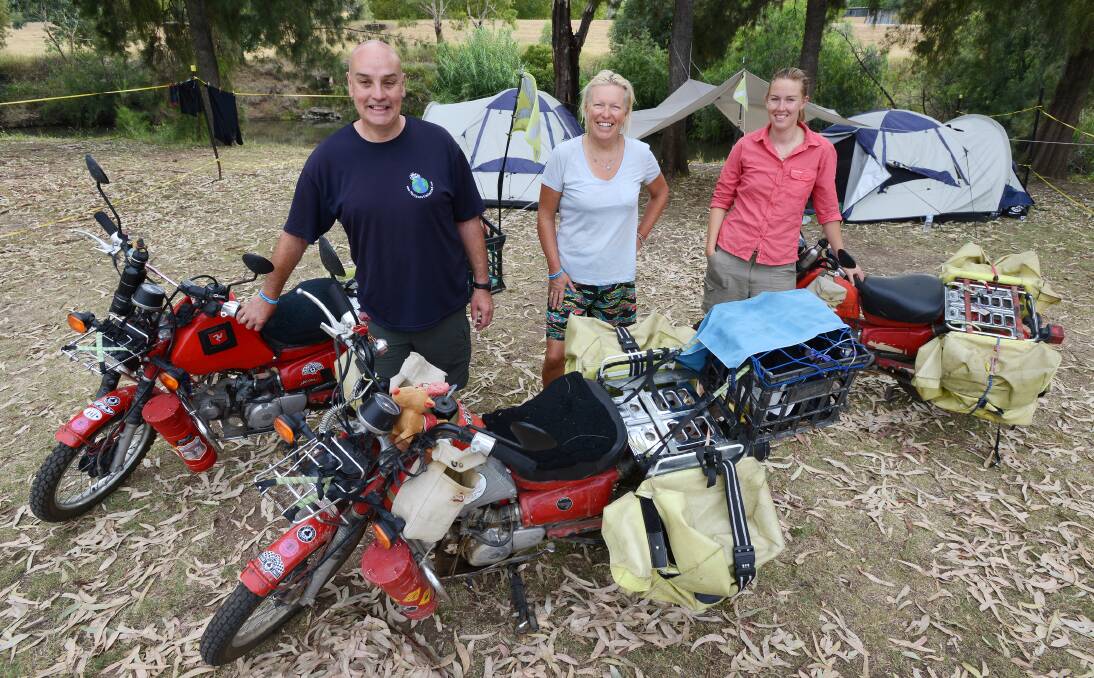 LOW RIDERS: Arriving at Riverside camping grounds with their fully loaded postie bikes are Gordon and Belle Sinclair and fellow traveller Nadine Holfter. Photo: Barry Smith 200114BSB01